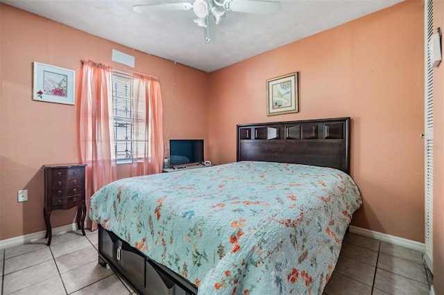 bedroom featuring tile patterned floors, a ceiling fan, and baseboards