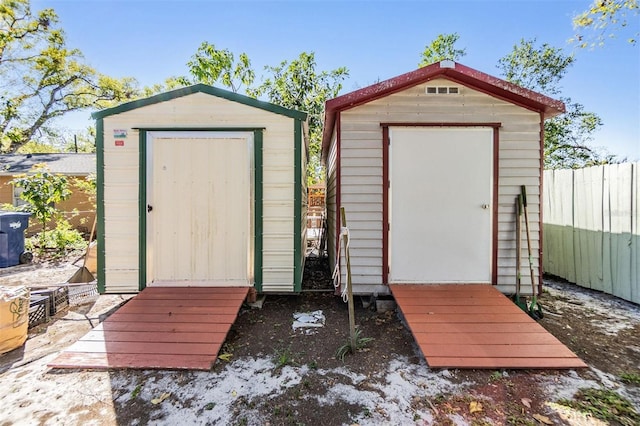 view of shed featuring fence