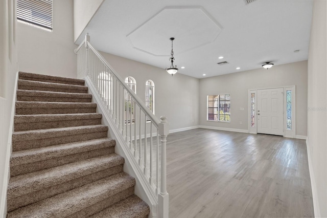 entryway featuring stairs, baseboards, wood finished floors, and recessed lighting