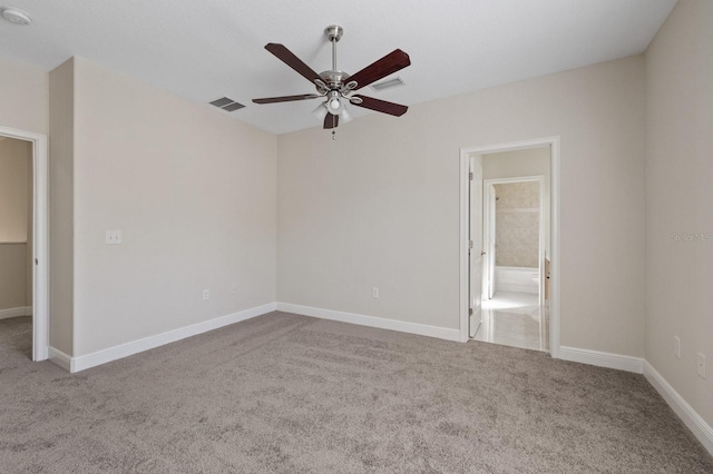 empty room with a ceiling fan, baseboards, visible vents, and carpet flooring