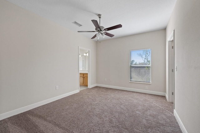 unfurnished bedroom with visible vents, light carpet, baseboards, and ensuite bathroom