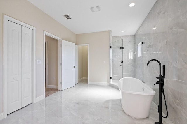 full bathroom with visible vents, marble finish floor, a closet, a soaking tub, and a stall shower