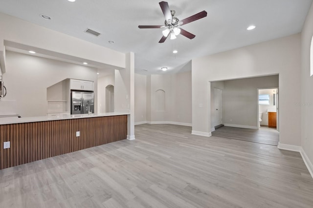 unfurnished living room featuring visible vents, baseboards, light wood-style flooring, ceiling fan, and recessed lighting