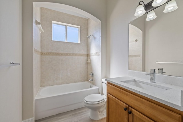 full bathroom featuring toilet, shower / bath combination, wood finished floors, and vanity