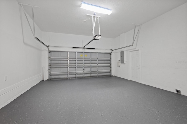 garage with a garage door opener and electric panel