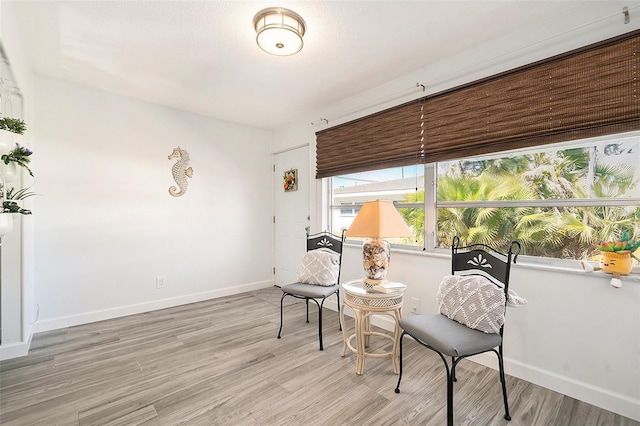 sitting room featuring light wood-style floors and baseboards