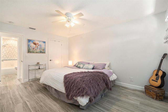 bedroom featuring light wood-style floors, visible vents, ceiling fan, and baseboards