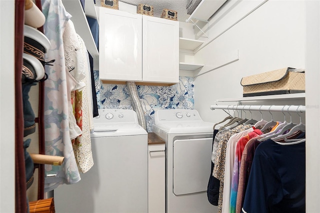 laundry area featuring cabinet space and washer and clothes dryer