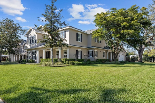 view of front facade featuring a front lawn and stucco siding