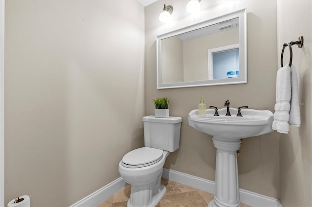 half bath featuring visible vents, tile patterned floors, toilet, and baseboards