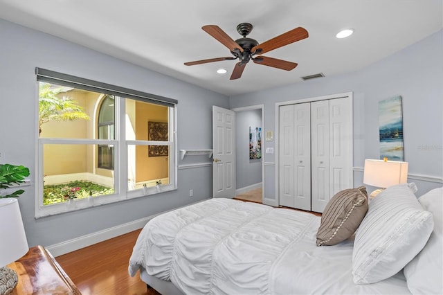 bedroom featuring baseboards, visible vents, wood finished floors, and recessed lighting