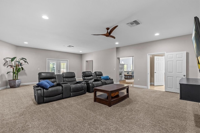 living room featuring light carpet, recessed lighting, visible vents, and french doors