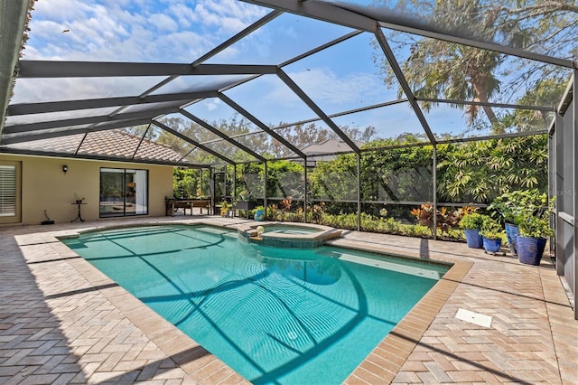 view of pool with a lanai, a patio area, and a pool with connected hot tub