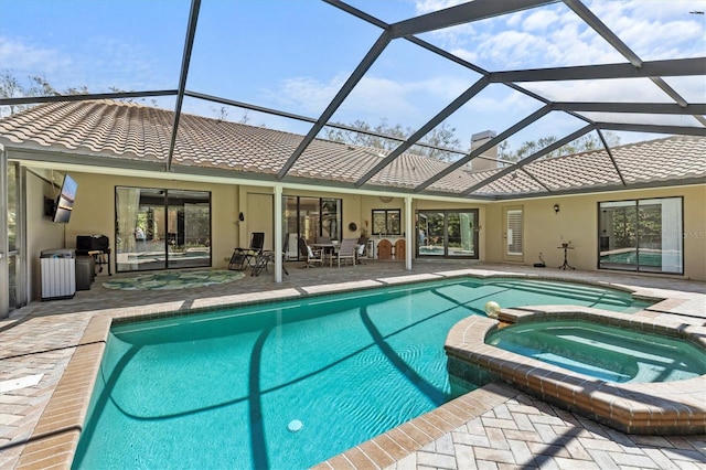 view of swimming pool with a patio area and a pool with connected hot tub