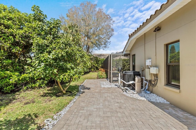 view of patio with a lanai and central AC unit