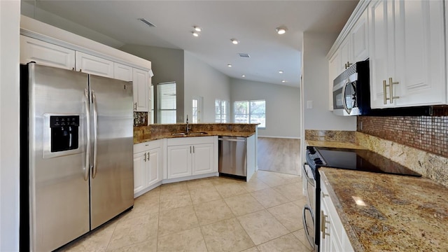 kitchen featuring a peninsula, white cabinets, visible vents, and appliances with stainless steel finishes