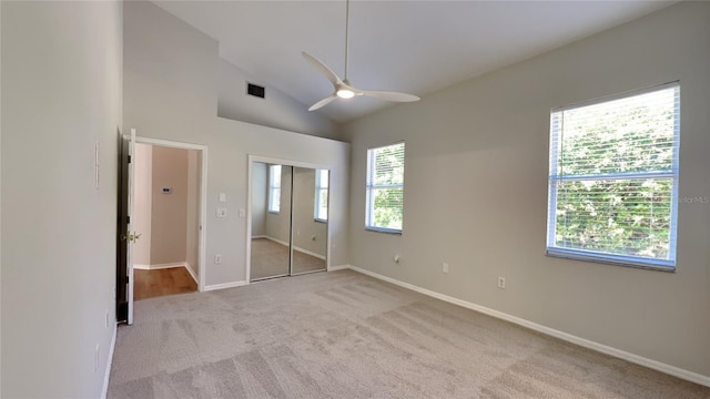 unfurnished bedroom featuring visible vents, baseboards, high vaulted ceiling, and carpet flooring