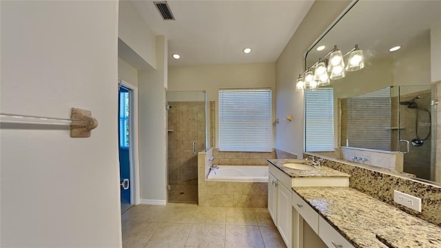 bathroom with vanity, visible vents, tile patterned flooring, a shower stall, and a garden tub