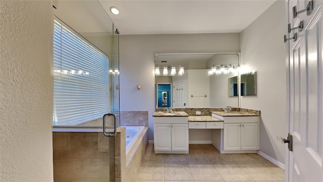 bathroom with a bath, a sink, a stall shower, and two vanities