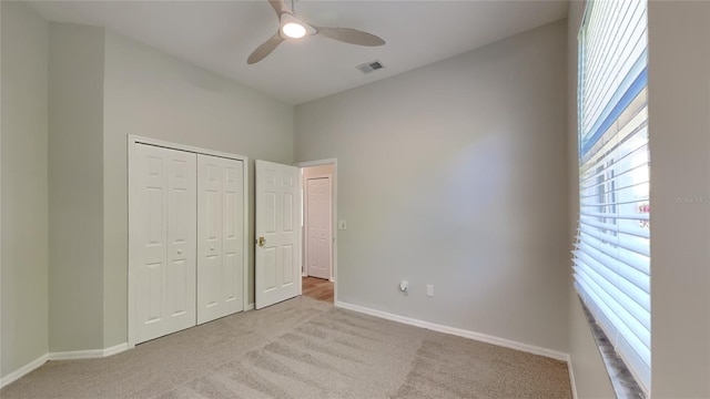 unfurnished bedroom featuring a closet, visible vents, carpet flooring, and baseboards