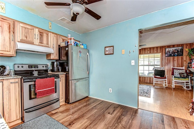 kitchen with stainless steel appliances, visible vents, light brown cabinetry, light wood-style floors, and under cabinet range hood