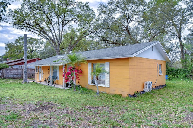 exterior space featuring a front lawn and fence