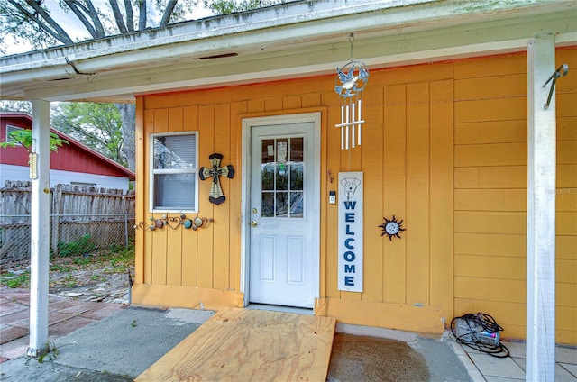 doorway to property with fence