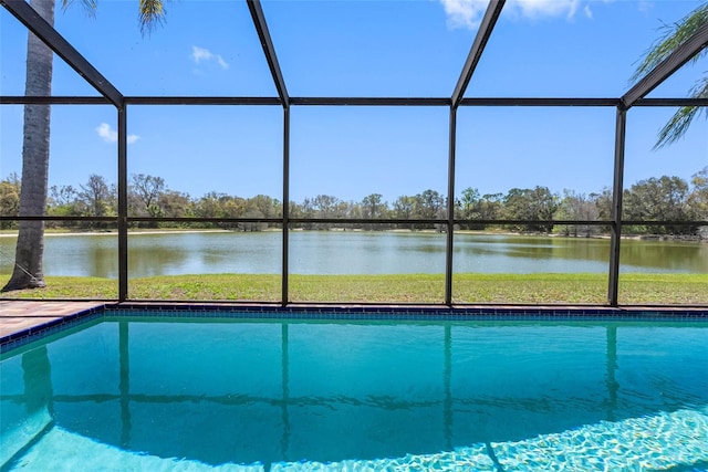 pool with glass enclosure and a water view