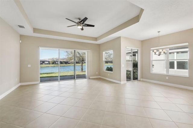 unfurnished room with baseboards, a raised ceiling, and light tile patterned flooring