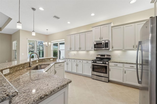 kitchen featuring recessed lighting, visible vents, backsplash, appliances with stainless steel finishes, and a sink