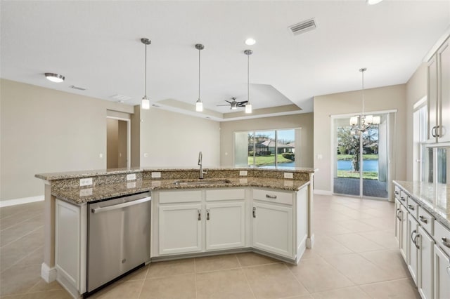 kitchen featuring light tile patterned floors, visible vents, a raised ceiling, stainless steel dishwasher, and a sink