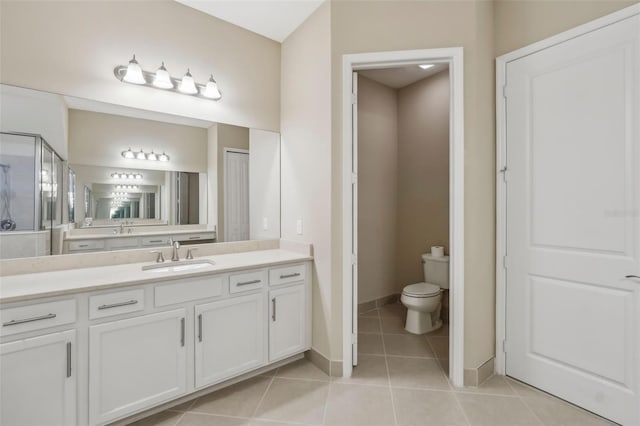 full bath with tile patterned flooring, toilet, vanity, baseboards, and a stall shower