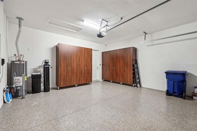 garage featuring gas water heater, concrete block wall, and a garage door opener