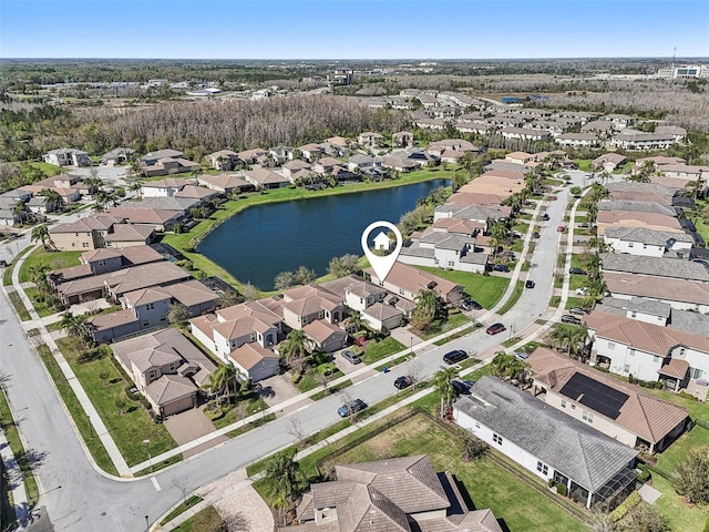 drone / aerial view featuring a water view and a residential view