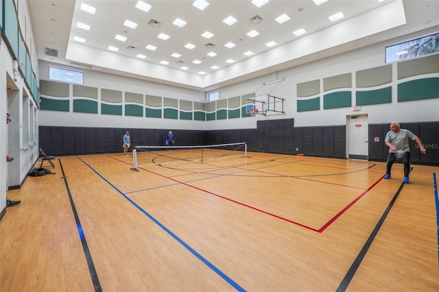 view of basketball court featuring a tennis court, community basketball court, and fence