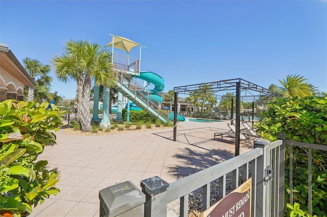 exterior space featuring fence, a patio, a community pool, and stairs