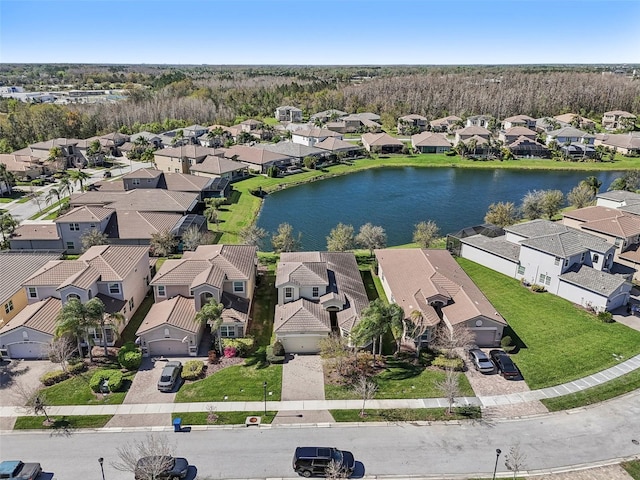 birds eye view of property featuring a water view and a residential view