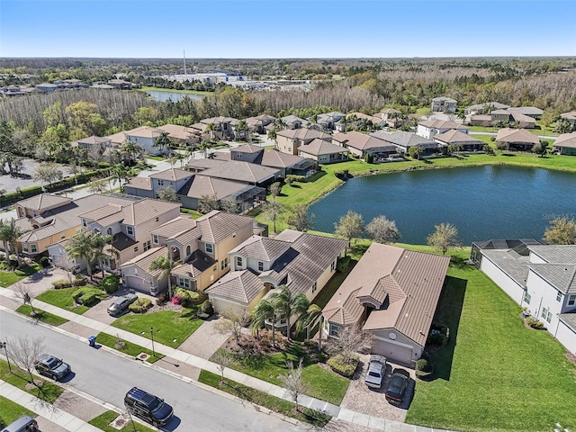 drone / aerial view with a water view and a residential view