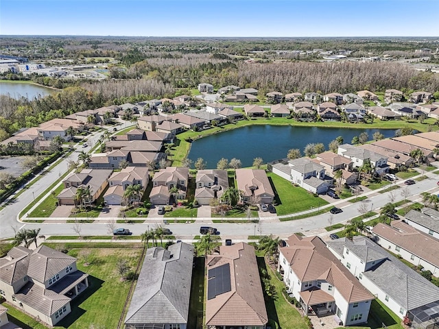 drone / aerial view featuring a water view and a residential view