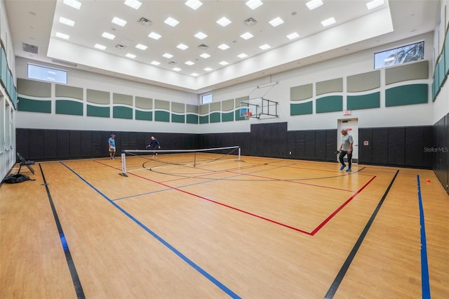 view of basketball court featuring a tennis court, community basketball court, and fence