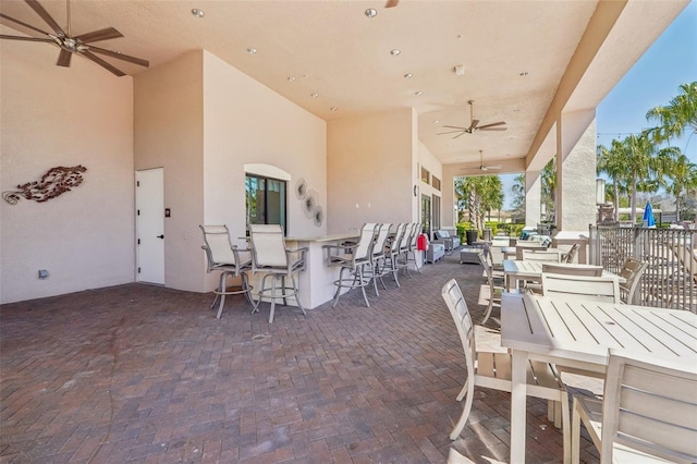 view of patio featuring a ceiling fan and outdoor dry bar