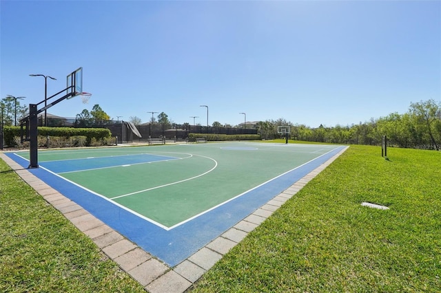 view of basketball court featuring community basketball court and a lawn