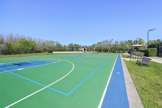 view of basketball court with community basketball court and a lawn