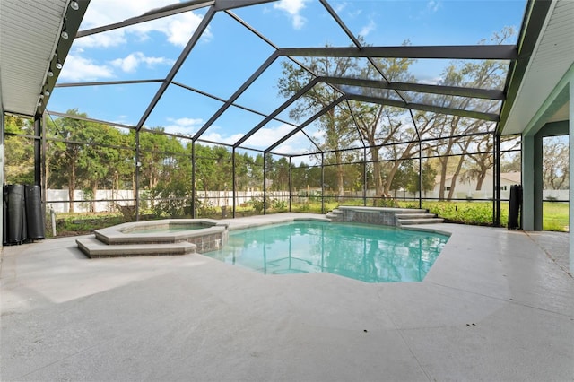 view of swimming pool featuring glass enclosure, a patio area, and a pool with connected hot tub