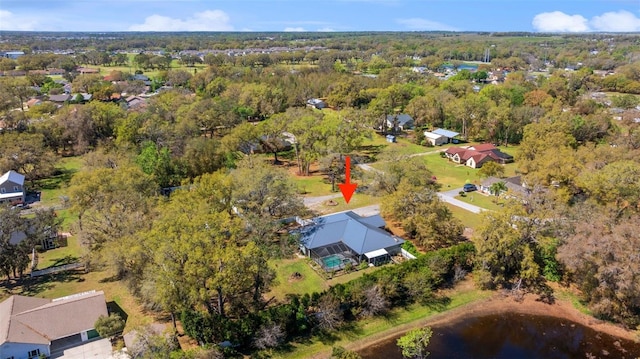 aerial view with a water view and a wooded view