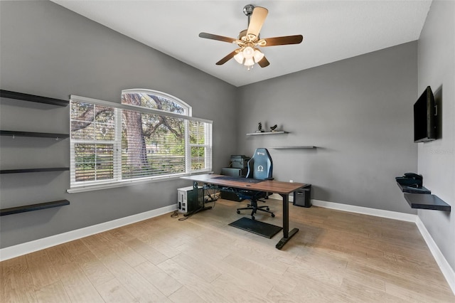 office area with a ceiling fan, wood finished floors, and baseboards