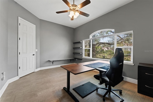 office featuring a ceiling fan, wood finished floors, and baseboards