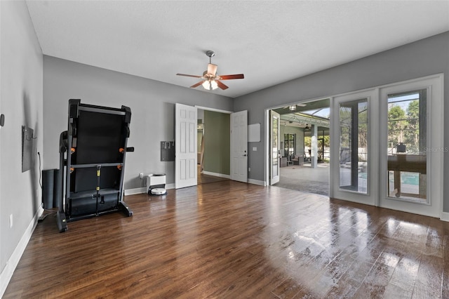 living area featuring ceiling fan, baseboards, and wood finished floors