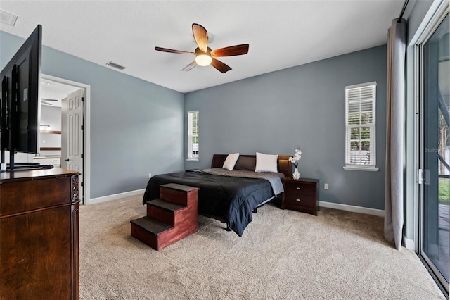 carpeted bedroom featuring visible vents, ceiling fan, and baseboards