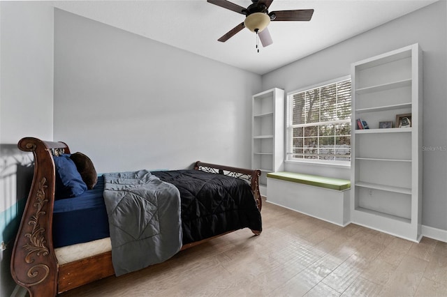 bedroom with wood finished floors, baseboards, and ceiling fan